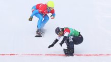 Lindsey Jacobellis of Team United States (R) and Michela Moioli of Team Italy (L) cross the finish line during the Snowboard Mixed Team Cross Big Final on day 8 of the 2022 Winter Olympics at Genting Snow Park on Feb. 12, 2022, in Zhangjiakou, China.