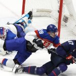 Martin Gernat #28 of Team Slovakia competes for control of the puck with Matt Knies #67 of Team United States during the Men’s Ice Hockey quarterfinal match at the 2022 Winter Olympic Games, Feb. 16, 2022, in Beijing.
