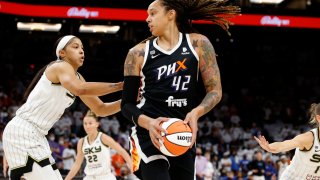 FILE – Phoenix Mercury center Brittney Griner (42) looks to pass as Chicago Sky center Candace Parker defends during the first half of game 1 of the WNBA basketball Finals , Sunday, Oct. 10, 2021, in Phoenix.