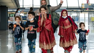 Afghan Refugees walking through airport terminal