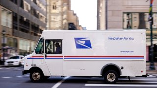 A United States Postal Service truck drives in Philadelphia, Thursday, March 3, 2022.