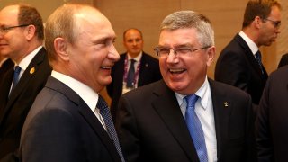 Russian President Vladimir Putin (left) chats with IOC President Thomas Bach