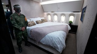 FILE - In this July 27, 2020 file photo, a soldier stands guard inside the former Mexican presidential plane during a media tour following the daily press conference of Mexican President Andres Manuel Lopez Obrador at Benito Juarez International Airport in Mexico City.