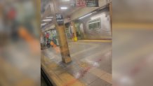 Injured subway riders seen on the platform of the 36th Street station in Brooklyn's Sunset Park neighborhood in New York, April 12, 2022. At least five people have been shot by a man in a gas mask and orange construction vest, according to the NYPD.