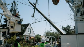 fix power lines following a tornado in Arabi, Louisiana.
