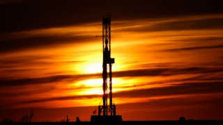FILE - An oil drilling rig is pictured at sunset, Monday, March 7, 2022, in El Reno, Okla. A federal appeals court in New Orleans hears arguments Tuesday, May 10, 2022, about whether President Joe Biden legally suspended new oil and gas lease sales because of climate change worries.