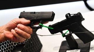 An attendee holds a Glock Ges.m.b.H. pistol during the National Rifle Association (NRA) annual meeting at the George R. Brown Convention Center, in Houston, Texas, on May 28, 2022.