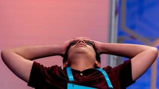 Chris Dominick, 14, from Struthers, Ohio, reacts as he competes during the Scripps National Spelling Bee, Wednesday, June 1, 2022, in Oxon Hill, Md.