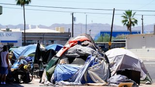 A homeless encampment grows in size just west of downtown Friday, May 20, 2022, in Phoenix.