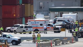 Safety officials at the Conley Container Terminal in Boston on Wednesday, June 15, 2022, after a person hit by a truck died.
