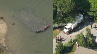 First responders conducting a missing person search in the water and organizing on land in Wareham, Massachusetts, on Thursday, June 16, 2022.