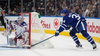 New York Rangers goaltender Igor Shesterkin (31) makes a save on a wraparound shot by Toronto Maple Leafs forward Auston Matthews (34) during overtime at Scotiabank Arena. (Credit: USA TODAY Sports)