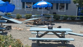 Smashed picnic tables at Tommy’s World Famous Clam Shack in Warwick, Rhode Island, on Friday, July 15, 2022.
