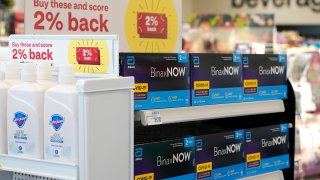 FILE - Boxes of BinaxNow home COVID-19 tests made by Abbott displayed for sale