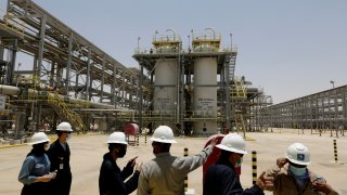 FILE - Saudi Aramco engineers and journalists look at the Hawiyah Natural Gas Liquids Recovery Plant in Hawiyah