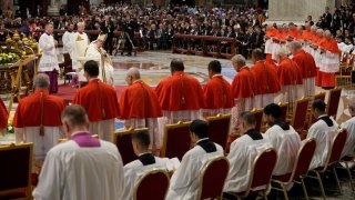 Pope Francis prays in front of new Cardinals during consistory inside St. Peter's Basilica
