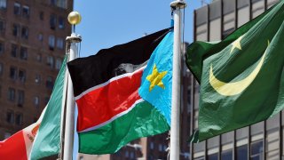 The flag of South Sudan (C) flies outside the United Nations after a flag raising ceremony on the day the General Assembly voted to admit the newly formed nation of South Sudan to the UN July 14, 2011 at UN headquarters in New York.