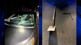 A car windshield that was smashed by construction equipment thrown from a bridge onto Interstate 93 in Manchester, New Hampshire, on the night of Thursday, Aug. 18, 2022. Two of the objects, a shovel and piece of rebar, are shown at right.