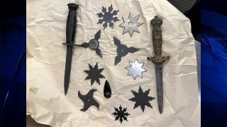 A collection of throwing stars, daggers an apparent arrowhead that were found at a TSA checkpoint at Boston Logan International Airport Sunday, Aug. 21, 2022.