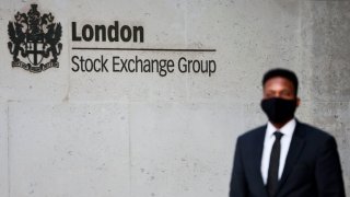 A security guard stands outside the London Stock Exchange building on December 29, 2020.