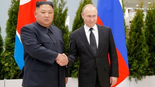 FILE - Russian President Vladimir Putin, right, and North Korea's leader Kim Jong Un shake hands