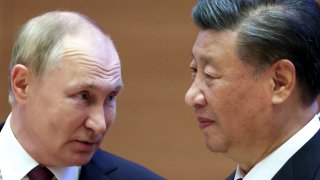 Russian President Vladimir Putin, left, speaks to Chinese President Xi Jinping