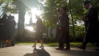 Graduates walk at a Harvard Commencement