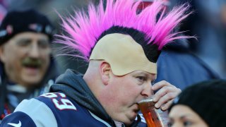 This 2016 file photo shows a fan drinking a beer at Gillette Stadium in Foxboro, Massachusetts, before the New England Patriots hosted the Kansas City Chiefs.