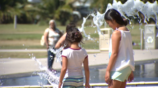 Two children play at a splash pad downtown San Diego, Sept. 1, 2022.