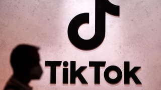 A visitor passes the TikTok exhibition stands at the Gamescom computer gaming fair in Cologne, Germany, Thursday, Aug. 25, 2022.