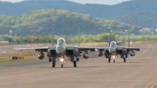In this image taken from video, South Korean Air Force's F15K fighter jets prepare to take off