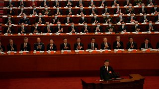 Delegates applaud as Chinese President Xi Jinping speaks