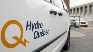 A close up of a Hydro-Quebec logo on a white van