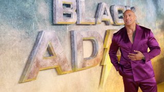 Dwayne Johnson poses for photographers upon arrival for the premiere of the film 'Black Adam'