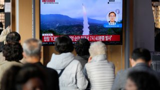 A TV screen showing a news program reporting about North Korea's missile launch