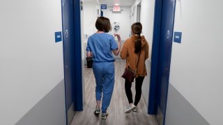 Dr. Elizabeth Brett Daily, left, walks with patient Haley Ruark