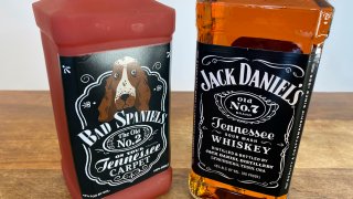 bottle of Jack Daniel's Tennessee Whiskey is displayed next to a Bad Spaniels dog toy