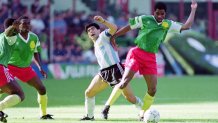 Diego Maradona of Argentina and Andre Kana-Biyik of Cameroon compete for the ball during the FIFA World Cup Italy Group B match between Argentina and Cameroon at the Stadio Giuseppe Meazza on June 8, 1990 in Milan, Italy.