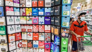Florida, Orlando, Publix supermarket, man in face mask shopping near gift cards display.