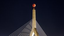 Picture shows Tuesday's lunar eclipse over the Zakim Bridge