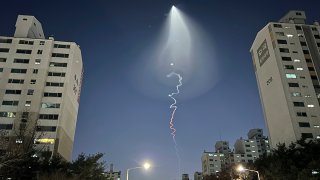 The light trail is seen in Goyang, South Korea, Dec. 30, 2022. South Korea's military confirmed it test-fired a solid-fueled rocket on Friday, after its unannounced launch triggered brief public scare of a suspected UFO or a North Korean missile or drone.