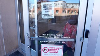 Signs are placed on the outside doors of city hall to advise visitors that the library as well as a restroom are closed because of meth contamination