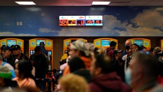 People wait in line at “The Lotto Store at Primm” just inside the California border Friday, Jan. 13, 2023, near Primm, Nev.