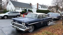 Belmont, MA - December 6: Old cars are set up around a neighborhood in Belmont, MA on December 6, 2021. The area is being transformed for the filming of the movie "Boston Strangler. (Photo by Jason Tuohey/The Boston Globe via Getty Images)