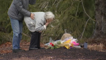 The great-grandmother of two slain children, Cora and Dawson Clancy, leaves flowers at their home on Summer Street in Duxbury, Massachusetts, on Wednesday, Jan. 25, 2023, a day after they were allegedly killed by their mother.