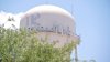 Mass. town orders resident projecting political signs on water tower to stop or face consequences