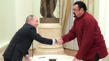 Russian President Vladimir Putin shakes hands with US action hero actor Steven Seagal after presenting a Russian passport to him during a meeting at the Kremlin in Moscow on November 25, 2016.