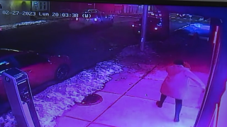Surveillance footage shows a woman chase after her stolen SUV, with her daughter inside, outside a barber shop in Lawrence, Massachusetts, on Monday, Feb, 27, 2023.
