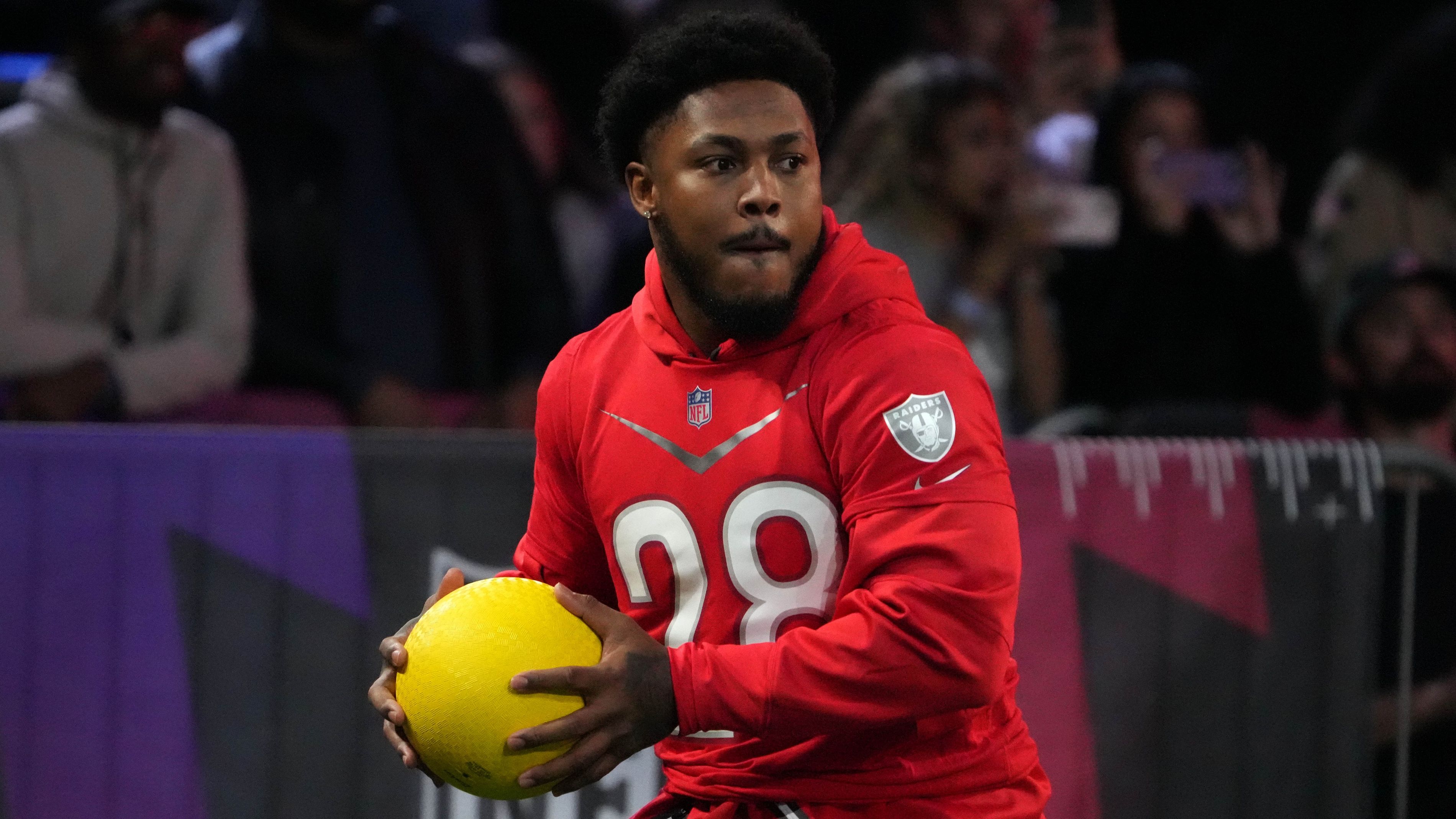 Feb 2, 2023; Henderson, NV, USA; Las Vegas Raiders running back Josh Jacobs (28) participates in dodge ball during the Pro Bowl Skills competition at the Intermountain Healthcare Performance Facility. Mandatory Credit: Kirby Lee-USA TODAY Sports