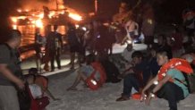 In this photo provided by the Philippine Coast Guard, survivors rest after being rescued from the still burning MV Lady Mary Joy at Basilan, southern Philippines early Thursday March 30, 2023.